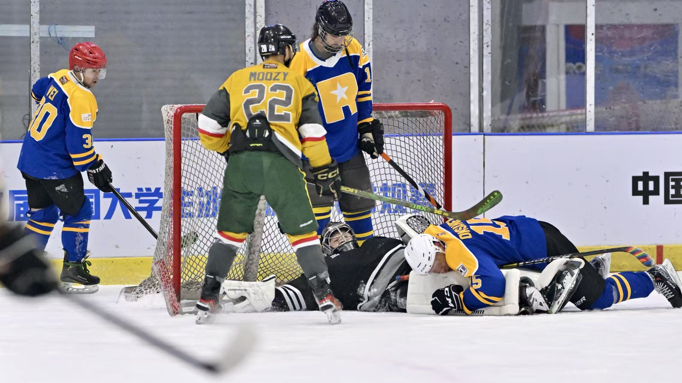 Players converging around a goalie during a scramble at the net